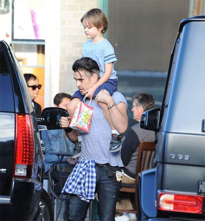 A photo of Colin carrying son in his shoulder's.